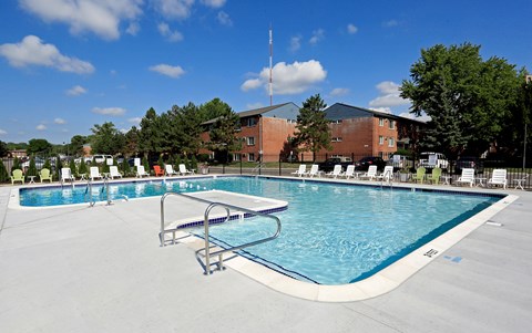 a swimming pool with a building in the background